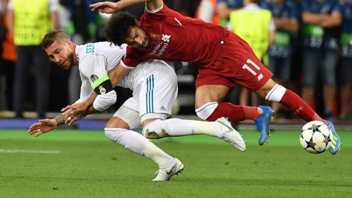 Liverpool's Mohamed Salah fouled by Real Madrid's Sergio Ramos during the Champions League final. - AFP file