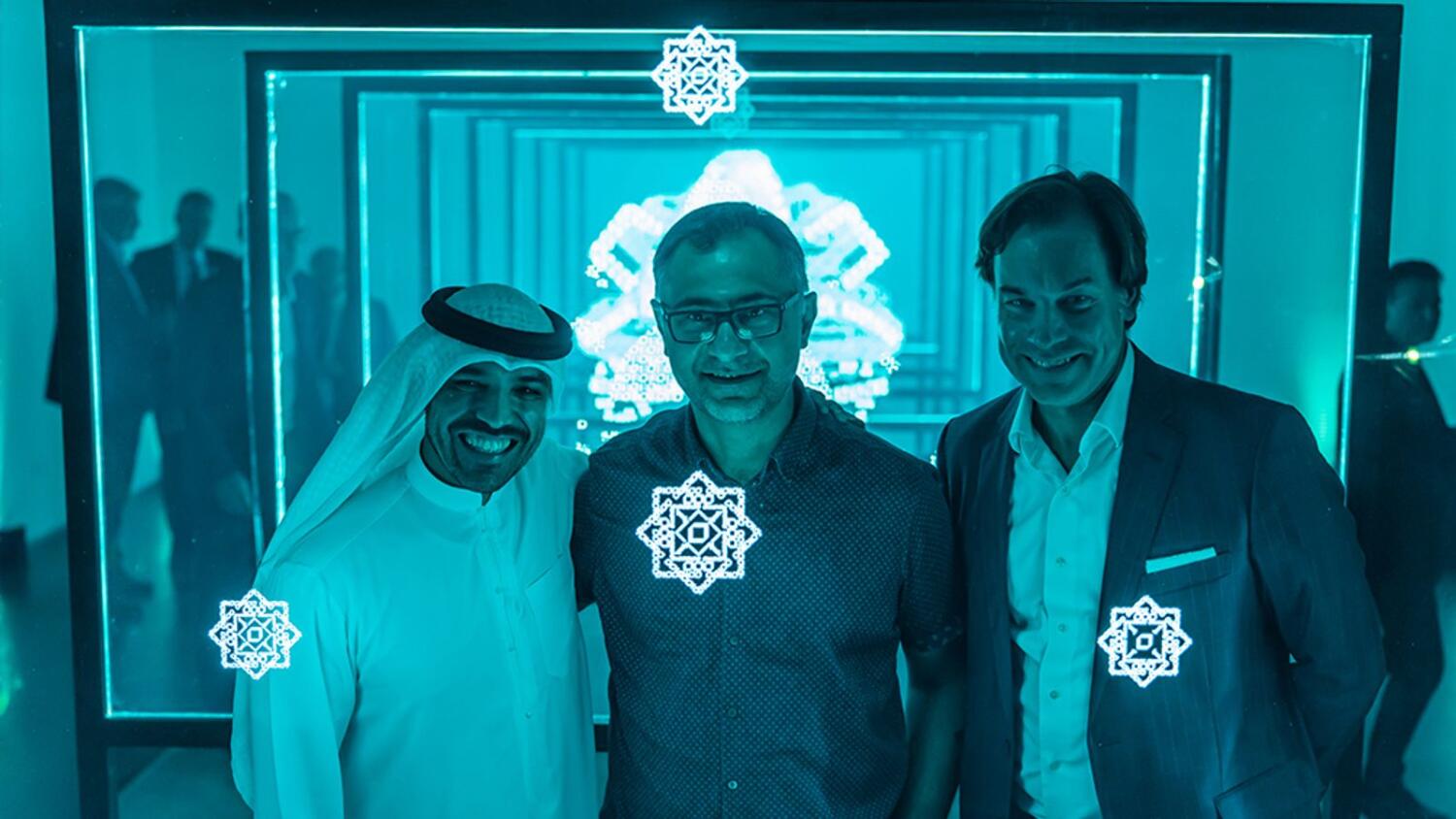 Siemens partnered with calligrapher and artist Wissam Shawkat (center) to create FABRIC, a unique perspective on the beauty, magic and vitality of numbers. (Right: Helmut von Struve, CEO of Siemens in the Middle East; left: Khalid Al Ameri, an Emirati content creator)