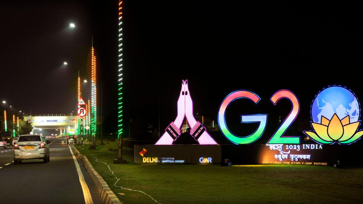 Traffics moves past an illuminated G20 logo near the New Delhi airport ahead of the Group of 20 nations' summit. (AP Photo)