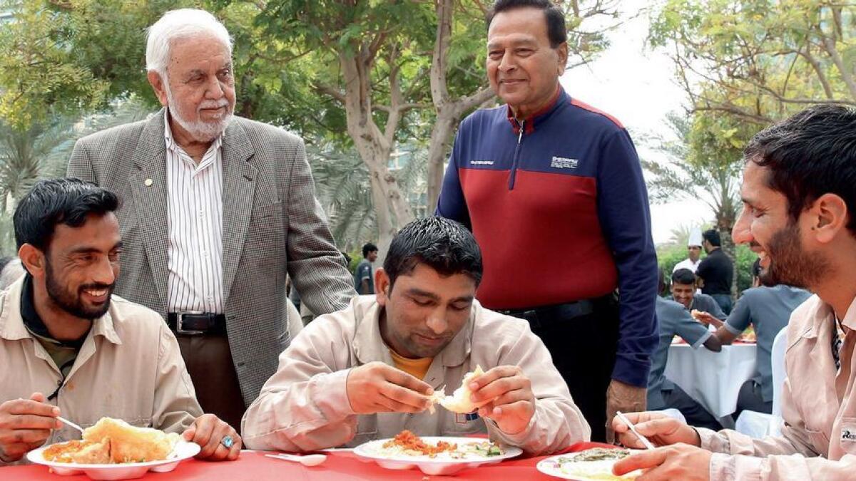 Naseem Durrani (standing left) with labourers during a Valentine’s Day surprise lunch organised by a senior citizen group in Dubai on Tuesday. More than 250 workers were invited to the  party. 