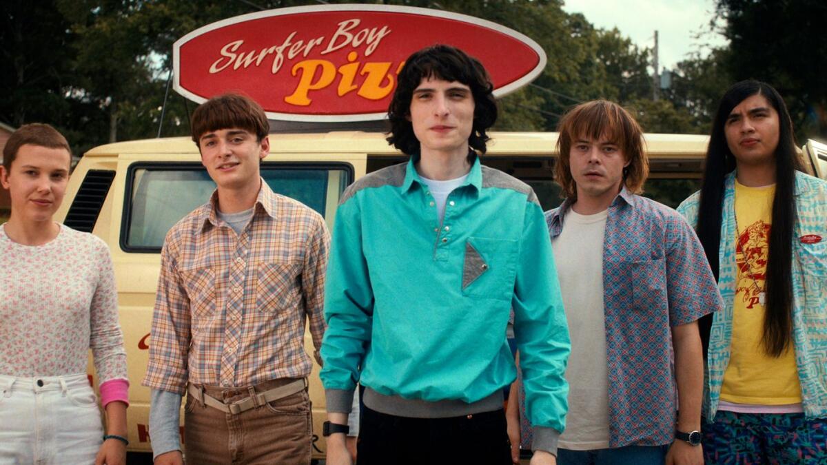 Millie Bobby Brown as Eleven, Noah Schnapp as Will Byers, Finn Wolfhard as Mike Wheeler, Charlie Heaton as Jonathan Byers, and Eduardo Franco as Argyle in 'Stranger Things'