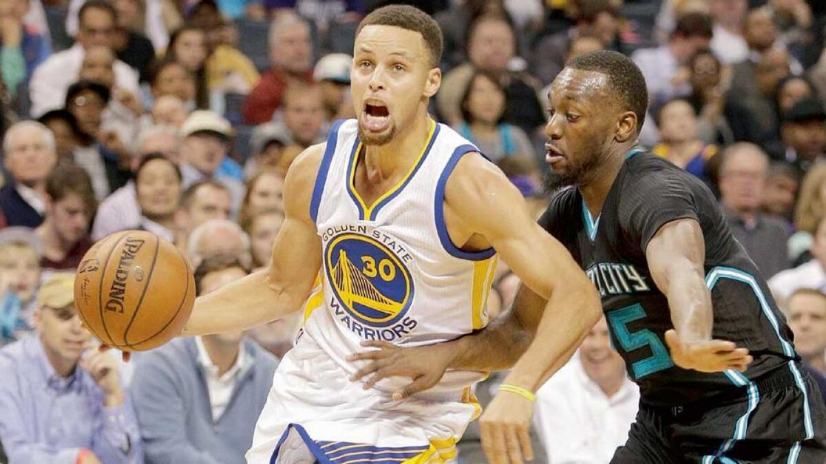 Stephen Curry (left) drives past Charlotte Hornets’ Kemba Walker to hand Warriors a 116-99 win. 