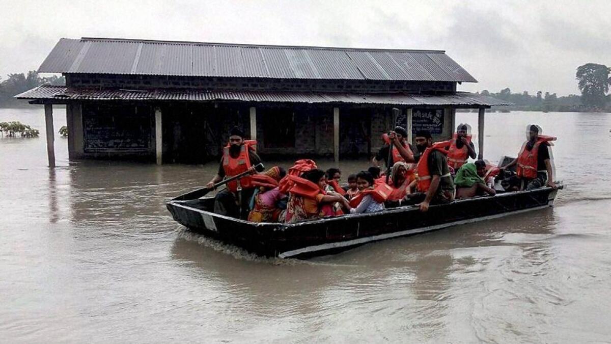 Army soldiers rescue flood affected villagers at Chirang district in Assam.   