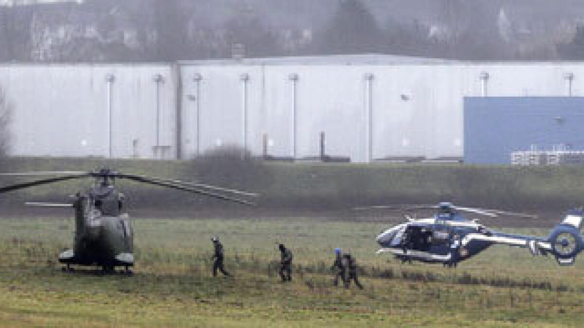 Twin hostage dramas as Paris massacre suspects cornered