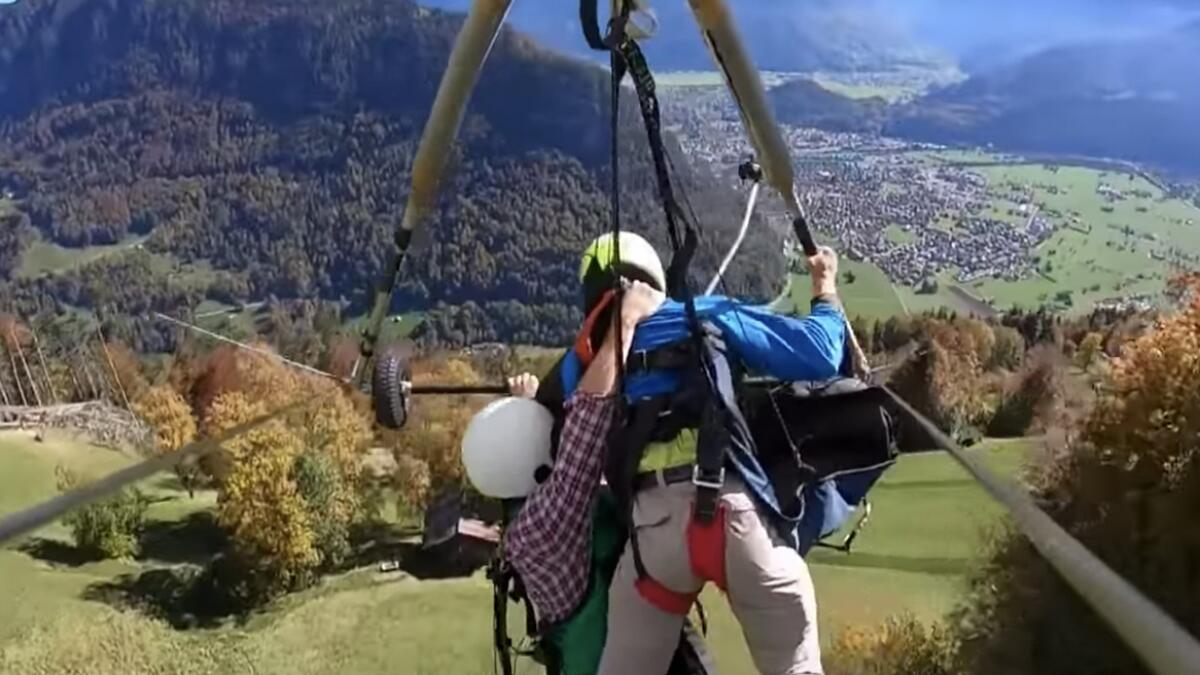 Video: Man on glider hangs on for life after pilot forgets harness