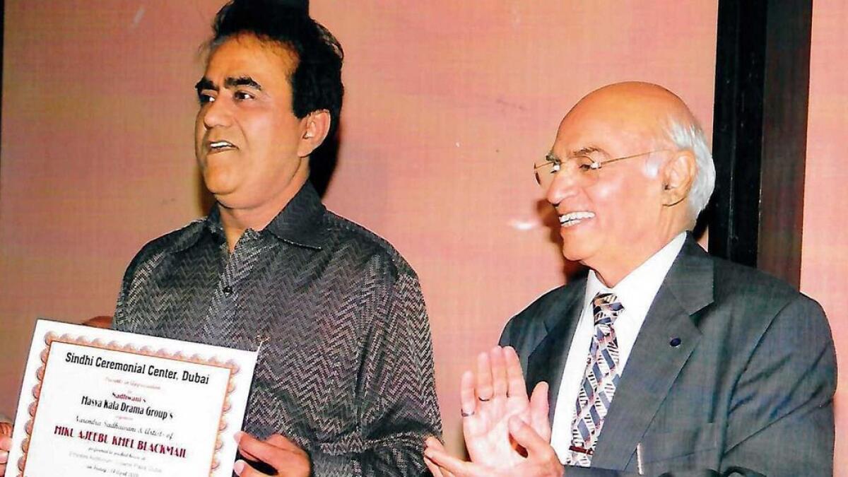 Narendra Sadhwani (left) receiving a certificate from Sindhi community leader Mari Sawlani for putting on the first Sindhi play in the UAE in 2006. 