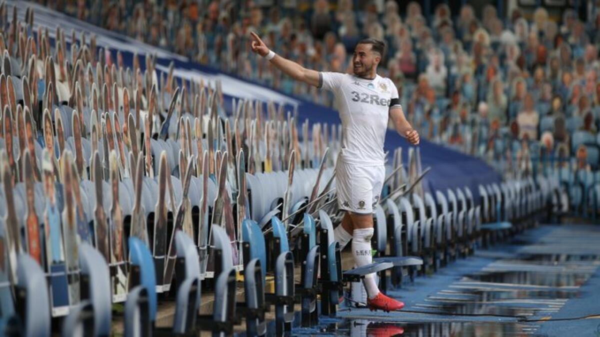 Leeds United's Jack Harrison celebrates among cardboard cut-outs of spectators after scoring against Fulham. - Twitter