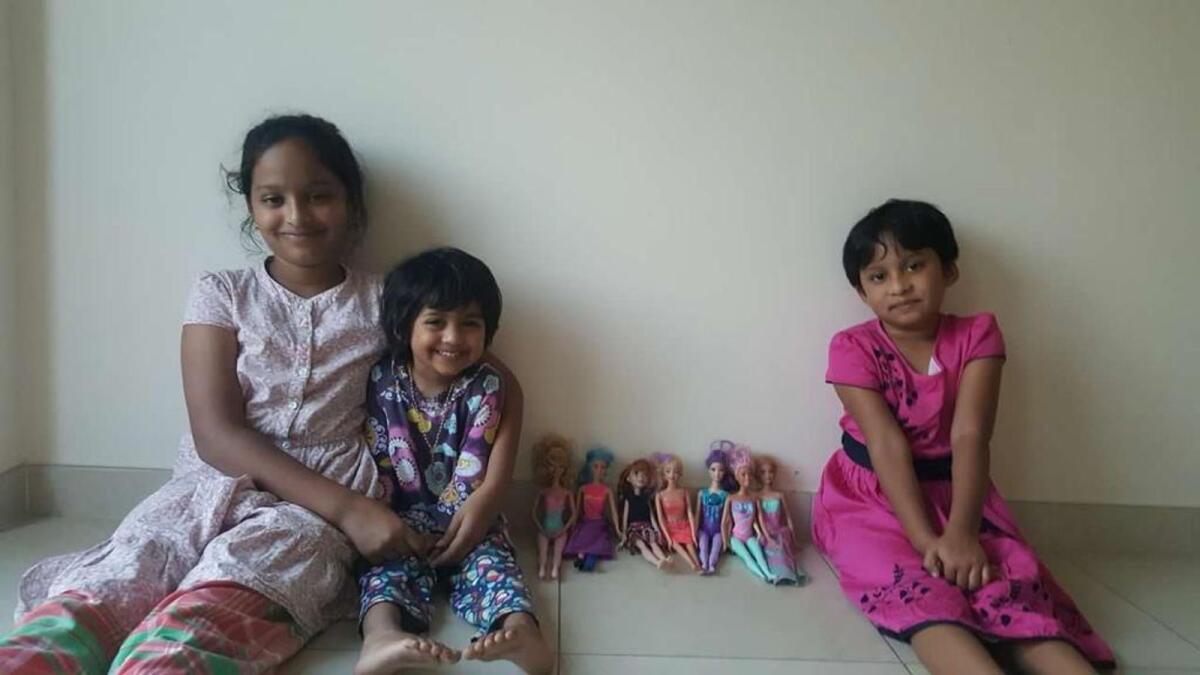 Ann’s daughters with their collection of Barbie dolls