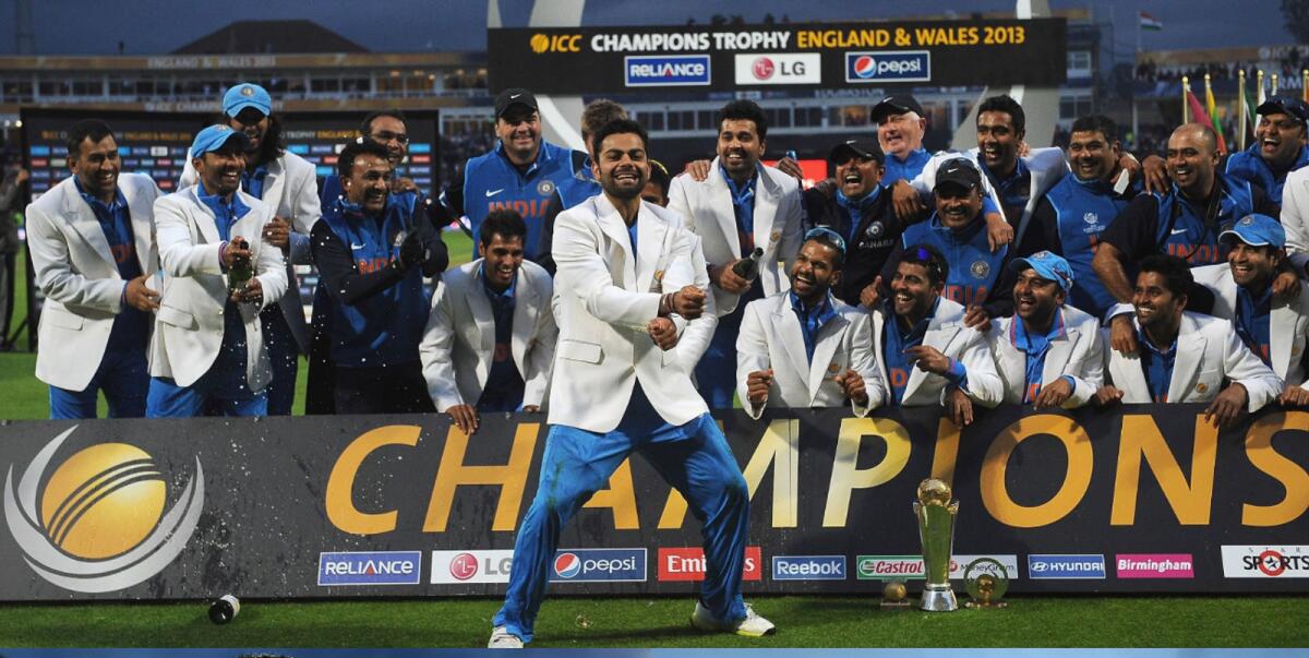 Virat Kohli dances as India celebrate with the Champions Trophy after winning the tournament in 2013. — AFP file