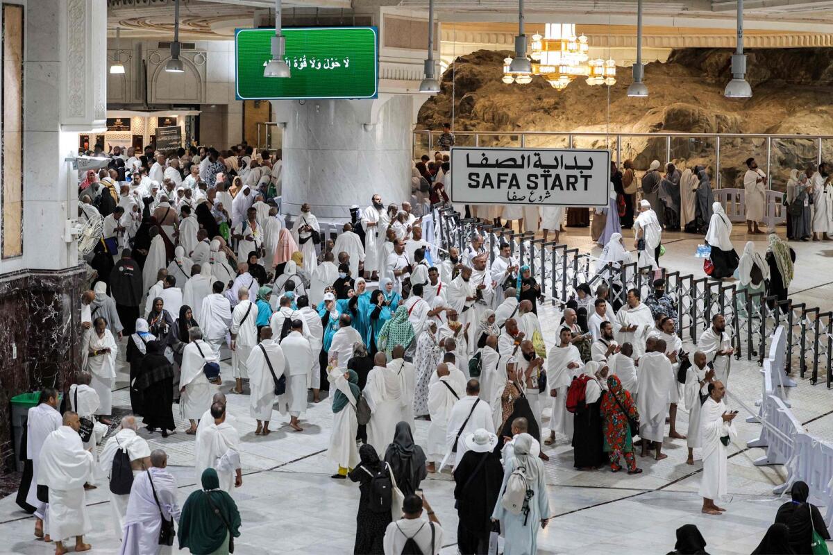 Muslim worshippers walk between the Marwa and Safa hills at the Grand Mosque on June 4, 2024. — AFP