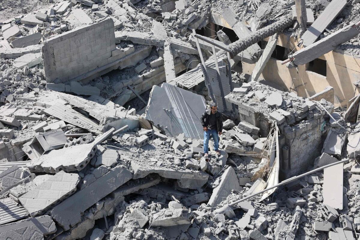 A Palestinian inspects the debris after Israeli bombardment at Al-Daraj neighbourhood in Gaza City on April 22, 2024. — AFP
