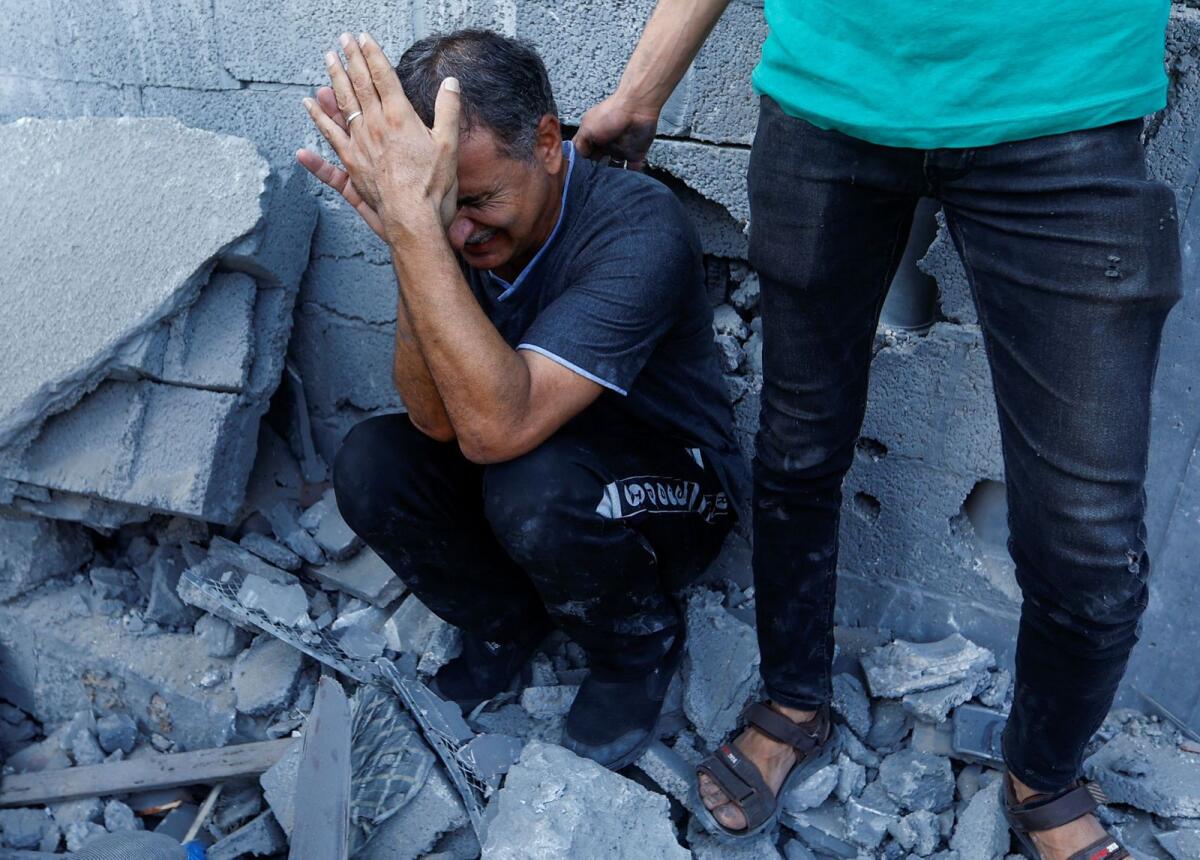 A Palestinian man reacts during a search for casualties following an Israeli strike on a house, in Khan Younis, in the southern Gaza Strip, October 25, 2023. Photo: Reuters