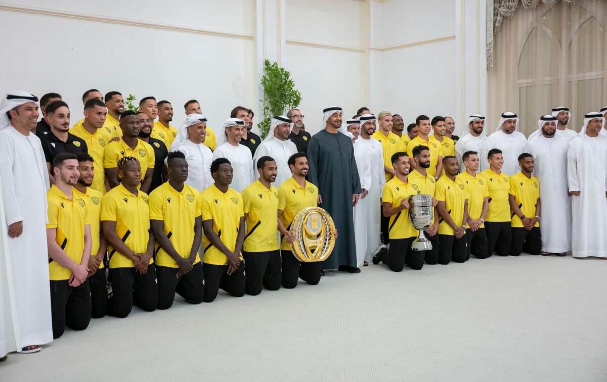 The President Sheikh Mohamed with members of the Al Wasl Club team. — WAM