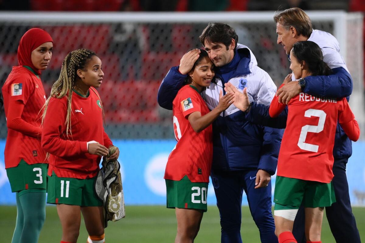 Morocco's coach Reynald Pedros (right) consoles his players after the end of the match against France. — AFP
