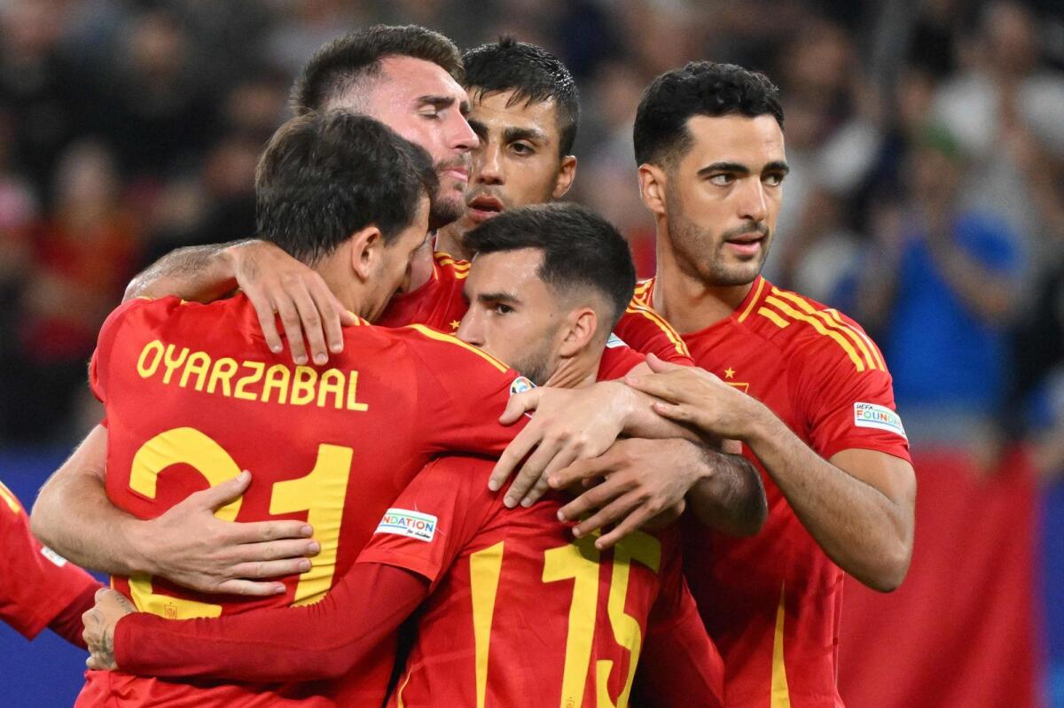 Spain's players celebrate on the pitch after the match. — AFP