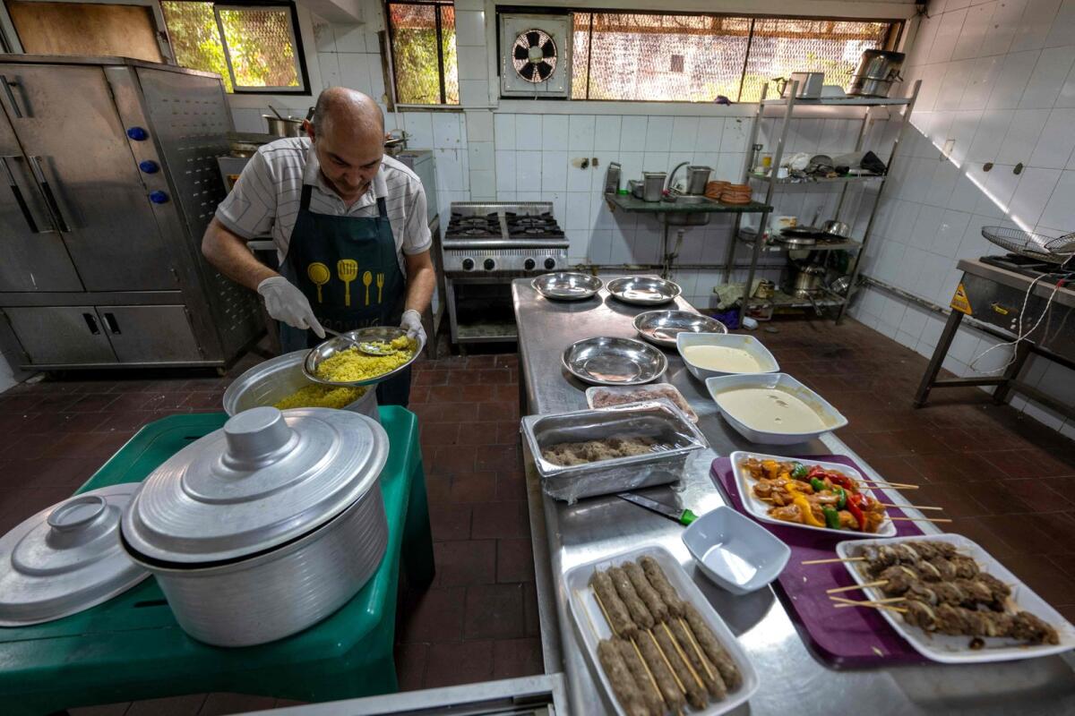 A Sudanese chief traditional food at a restaurant run by a businesswoman who relocated to the Egyptian capital Cairo after fleeing the ongoing war in Sudan, on May 21, 2024.  — AFP
