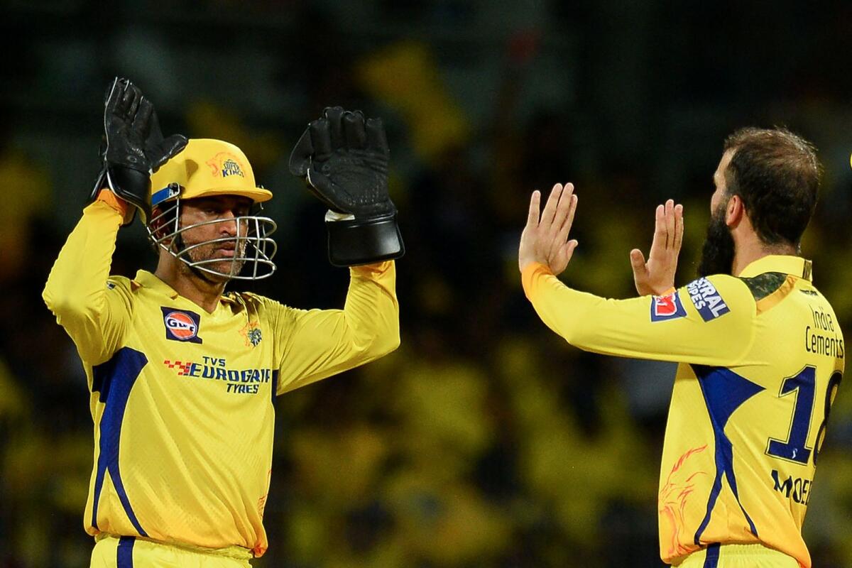 Chennai Super Kings' Moeen Ali (right) celebrates with his captain MS Dhoni after taking the wicket of Lucknow Super Giants' Krunal Pandya. — AFP