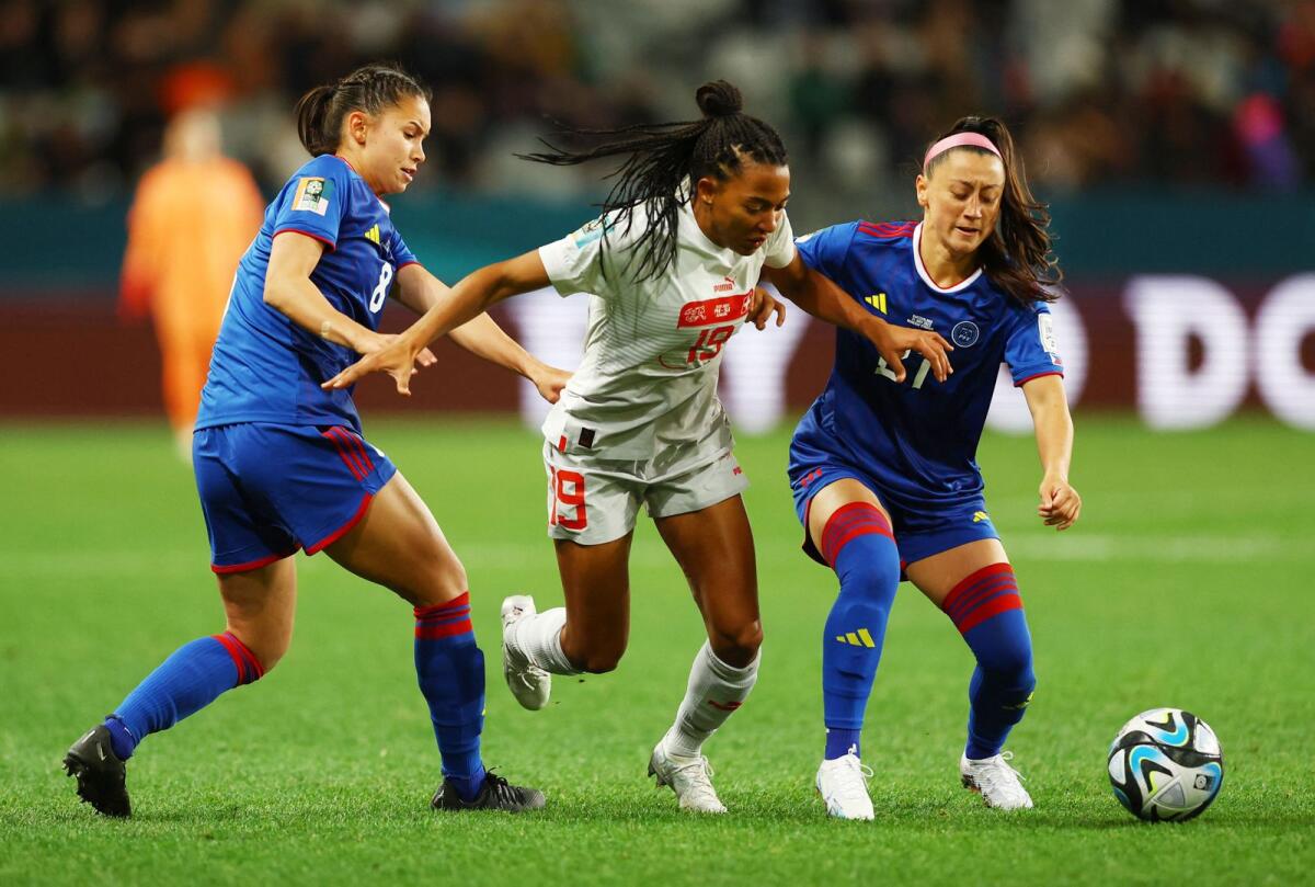 Philippines' Sara Eggesvik and Katrina Guillou attempt a steal from Switzerland's Eseosa Aigbogun. - Reuters