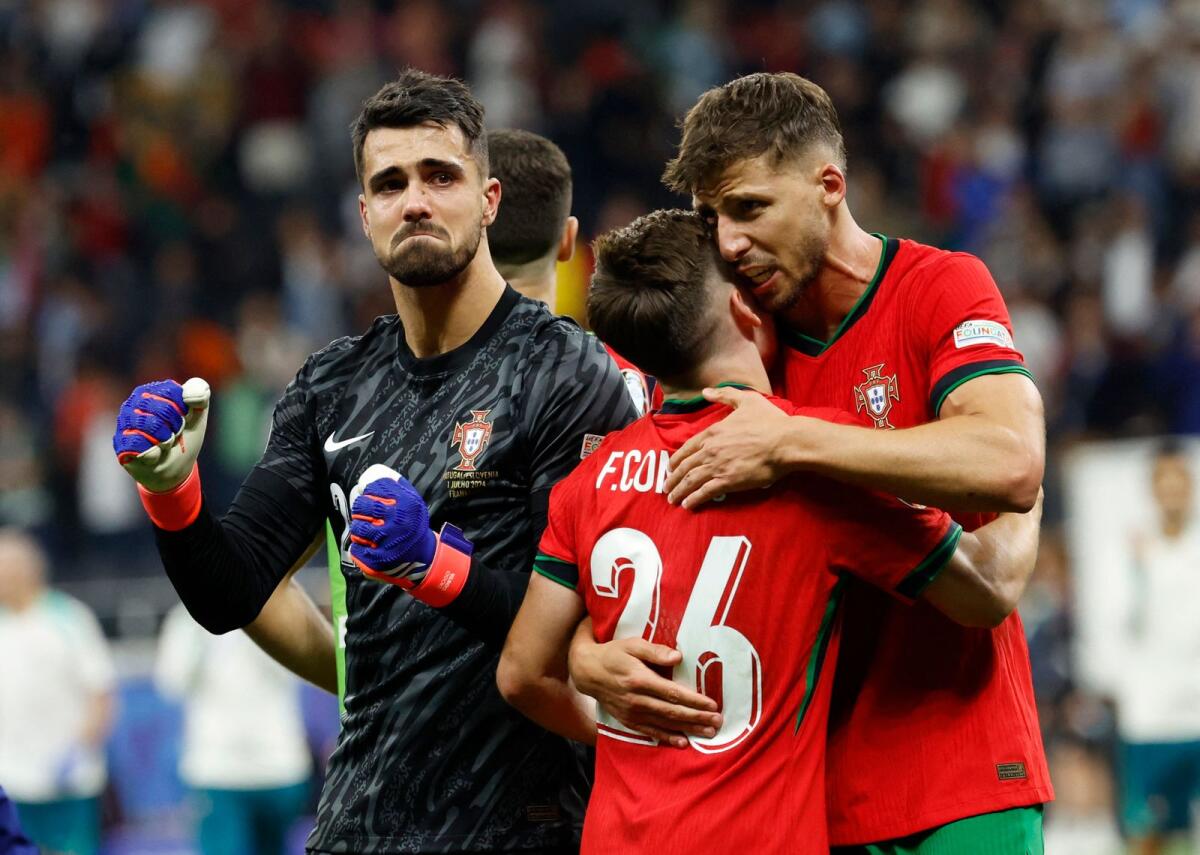 Portugal's Diogo Costa, Francisco Conceicao and Ruben Dias celebrate after winning the penalty shootout. — Reuters