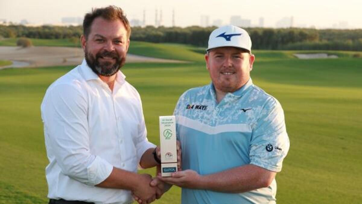 Jack Yule (Eng), winner of the Clutch Pro Tour event at Al Zorah Golf Club with Robert Fiala (left) of the Emirates Golf Federation. - Supplied photo