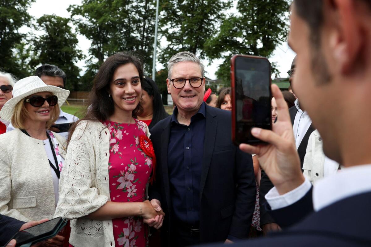 British opposition Labour Party leader Keir Starmer with Maahwish Mirza, Labour's Parliamentary candidate for Mid Bedfordshire, during a Labour general election campaign event, at Hitchin Town Football Club, in Hitchin, Britain, on Monday. — Reuters