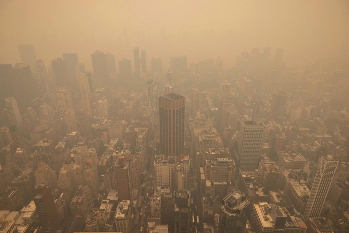 Haze is visible in New York City from the Empire State Building observatory on June 7, 2023. As smoky as the summer has been so far, scientists say it will likely be worse in future years because of climate change. — AP file