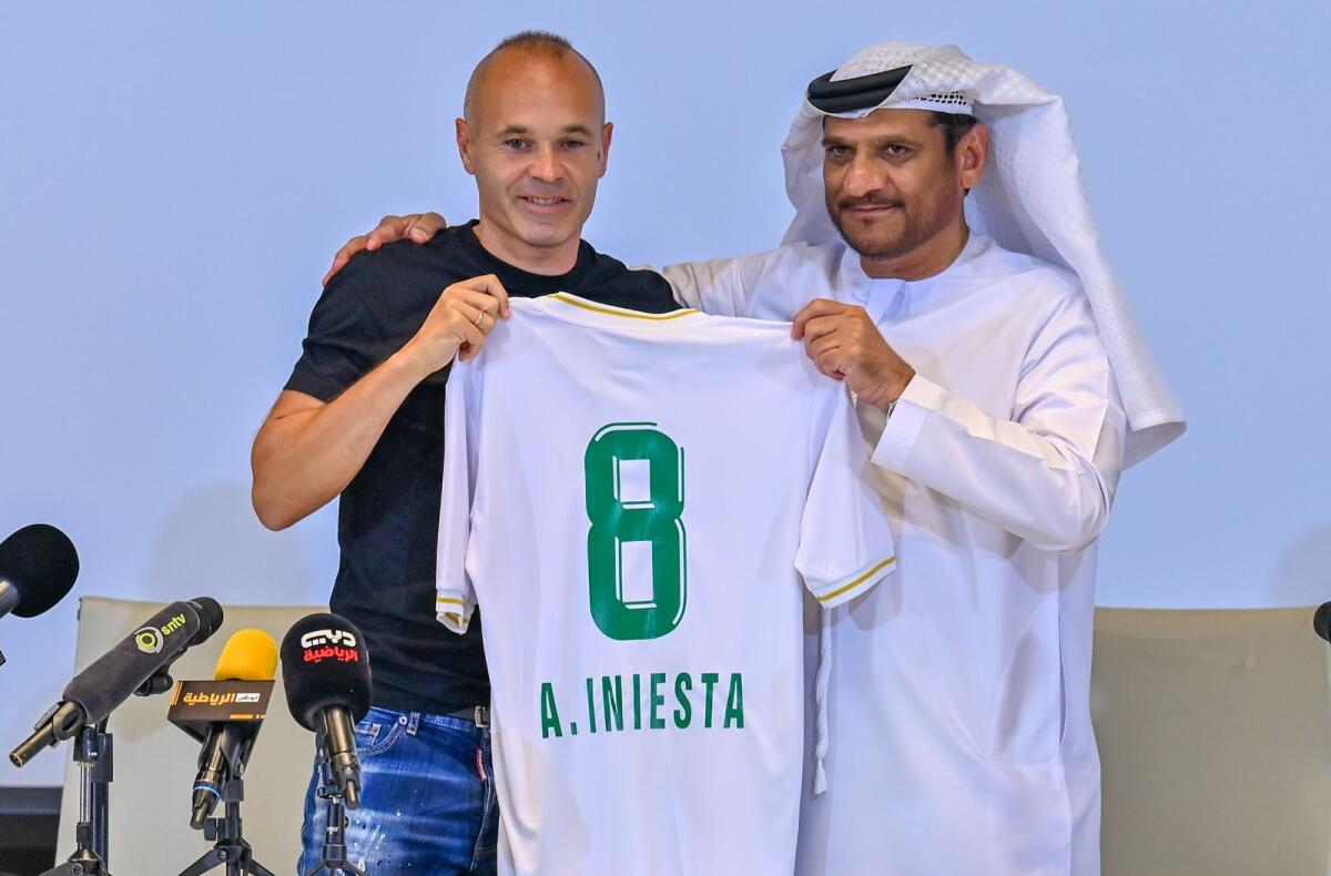 Spanish football legend Andres Iniesta holds his new club shirt as he poses with Youssef Abdullah Al Batran, chairman of Emirates Club, in Ras Al Khaimah.– Photo by M. Sajjad