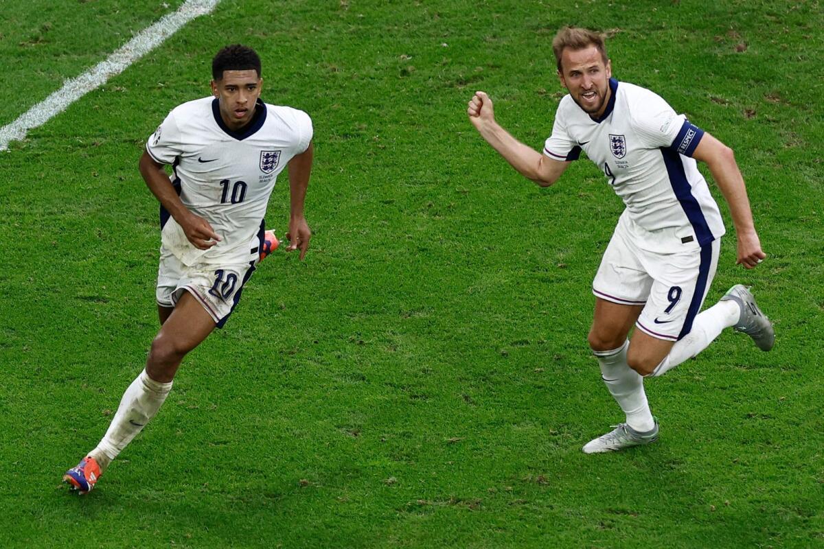 England midfielder Jude Bellingham (left) celebrates with Harry Kane after scoring his team's first goal. — AFP