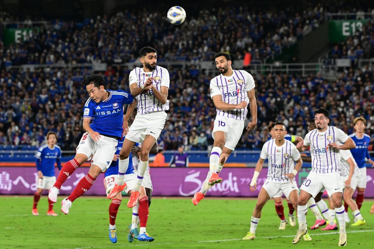 Al Ain's Emirati defender Khalid Al Hashemi (centre right) jumps to clear the ball for a corner kick during the AFC Champions League final first leg against Yokohama F. Marinos in Yokohama on May 11. — AFP