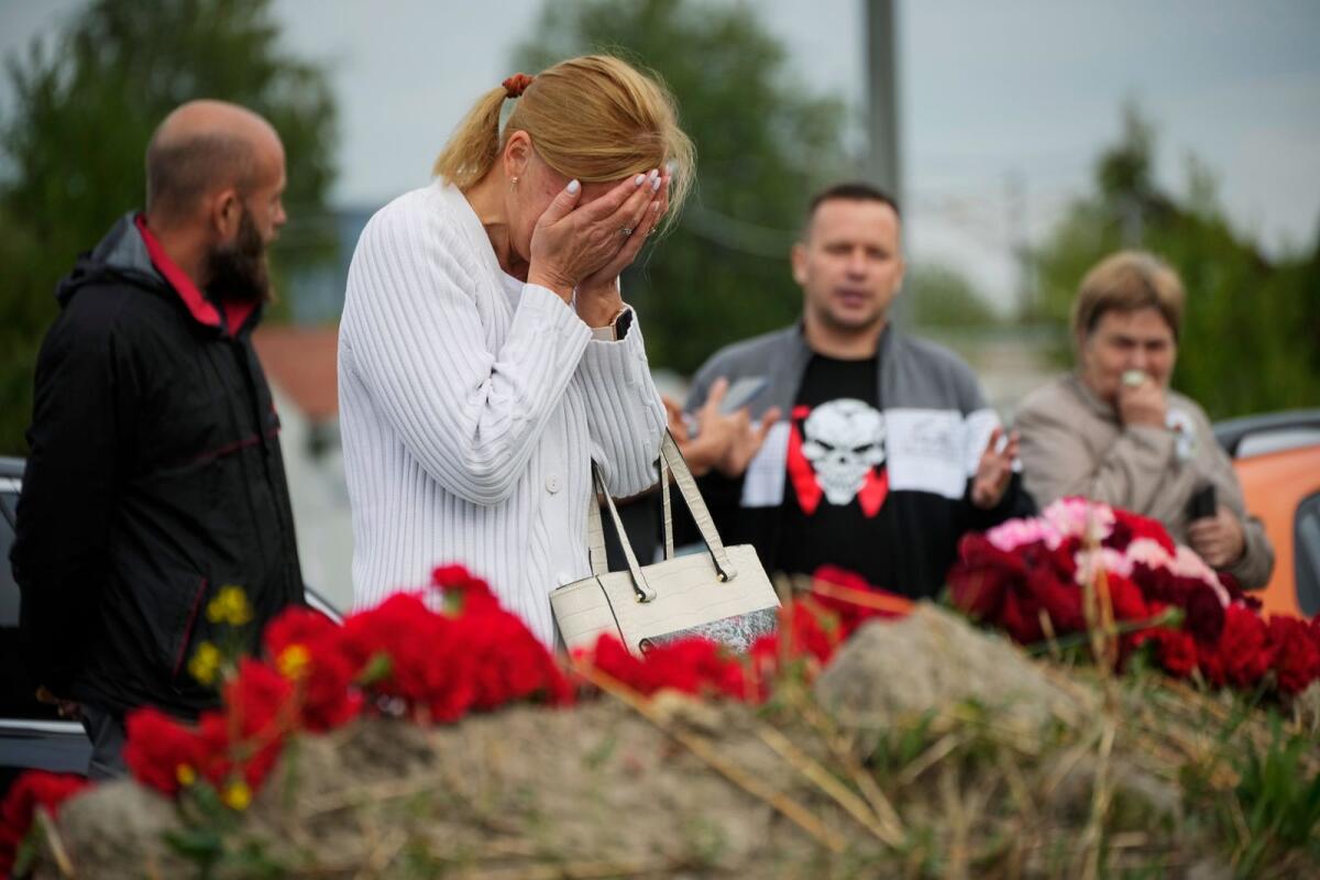 A woman reacts at an informal memorial next to the former 'PMC Wagner Centre' in St. Petersburg, Russia, on Thursday. — AP