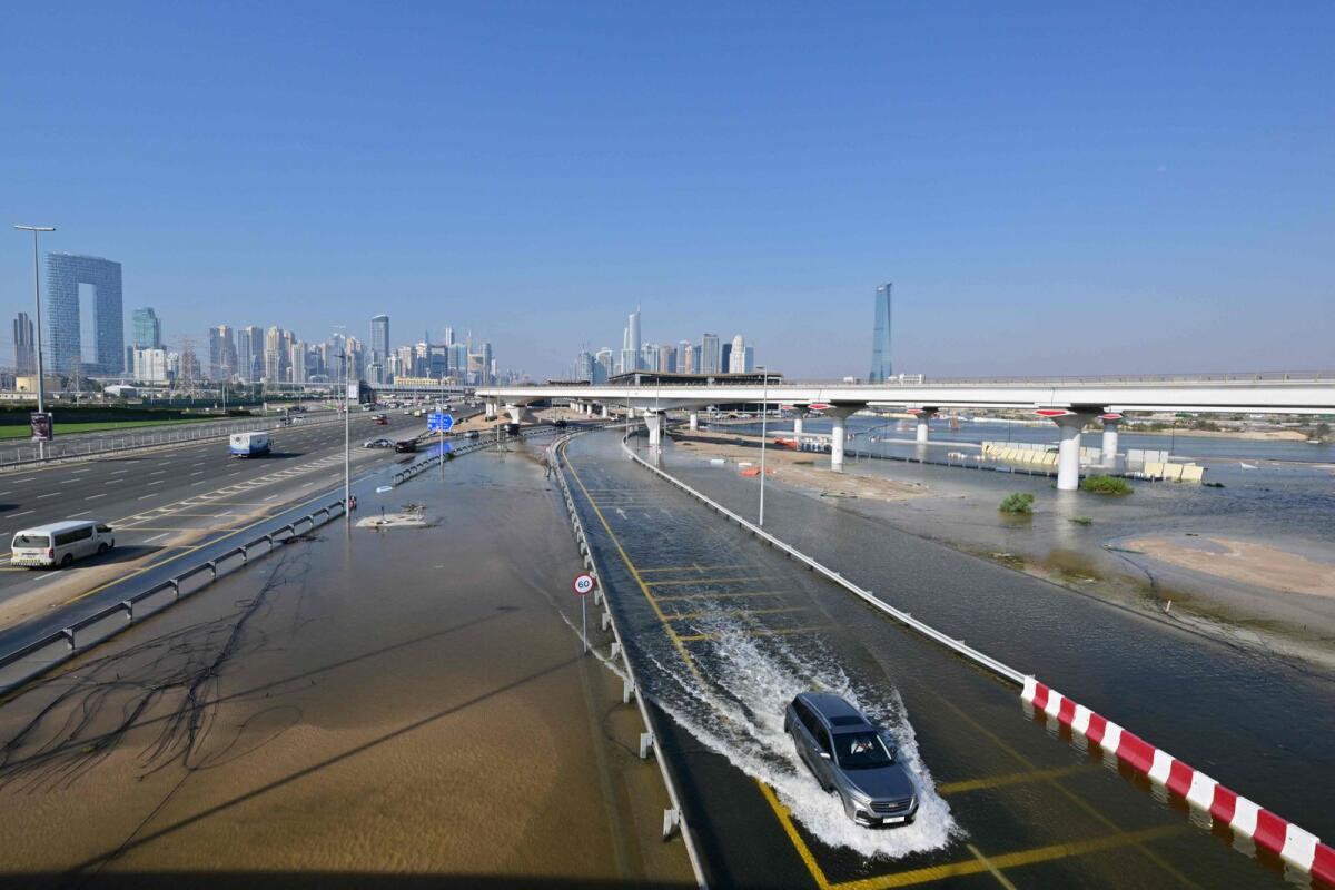 A car drives in a flooded road in Dubai on April 19, 2024. Photo: AFP
