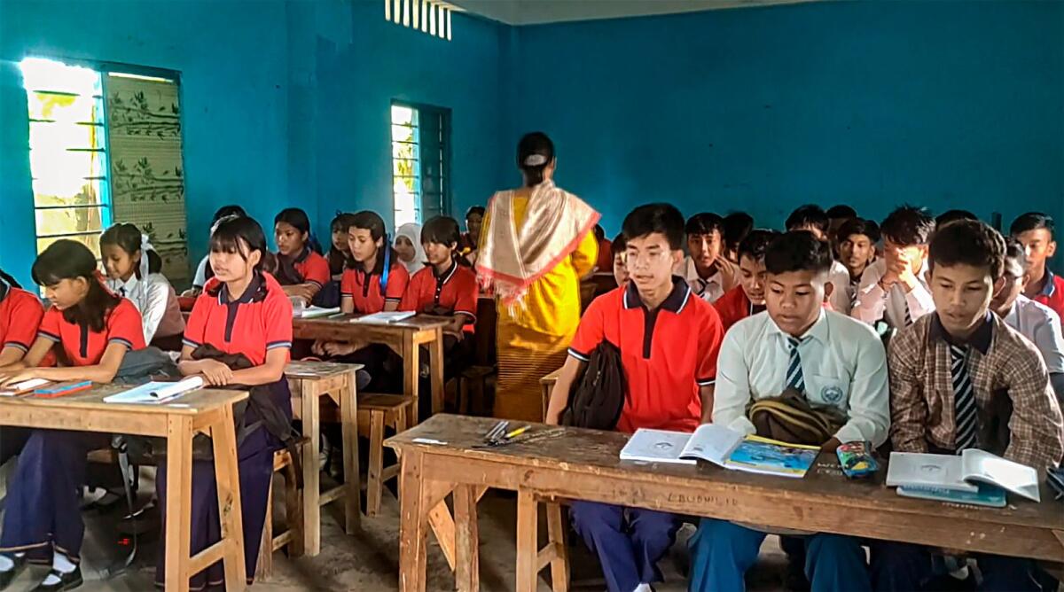 Students attend a class at a school that reopened after remaining shut for months because of ethnic clashes in Manipur on Wednesday. Photo: PTI