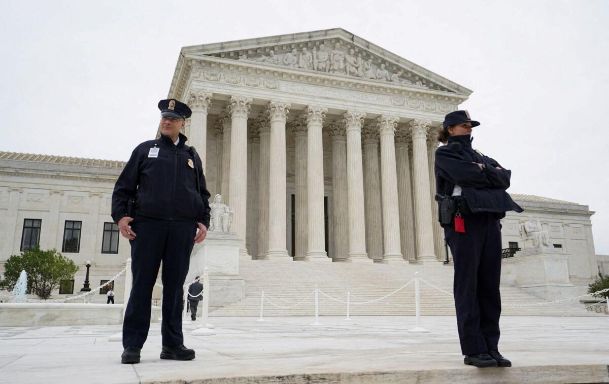 US Supreme Court police officers stand on the front steps of the Supreme Court building in Washington. — Reuters file