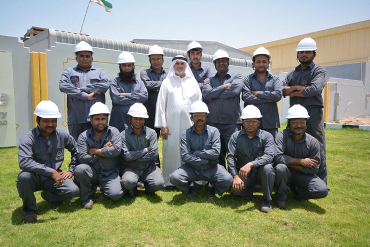 Abdul Raheem Qasem Al Marzouqi with factory employees.Photo: Provided