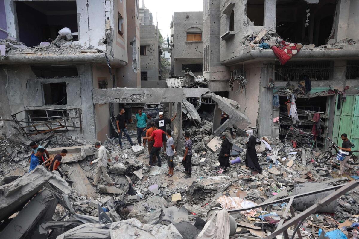 Palestinians inspect the damage and debris a day after an operation by the Israeli Special Forces in the Nuseirat camp, in the central Gaza Strip on June 9, 2024. Photo:   AFP
