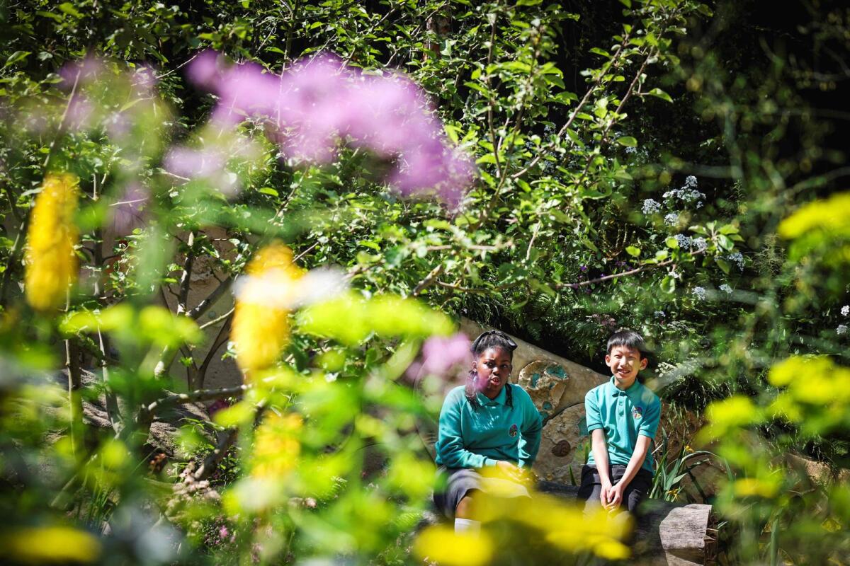 Students from Sulivan Primary School visit the No Adults Allowed Garden that they co-designed during the preview day at the RHS Chelsea Flower show in London  — AFP