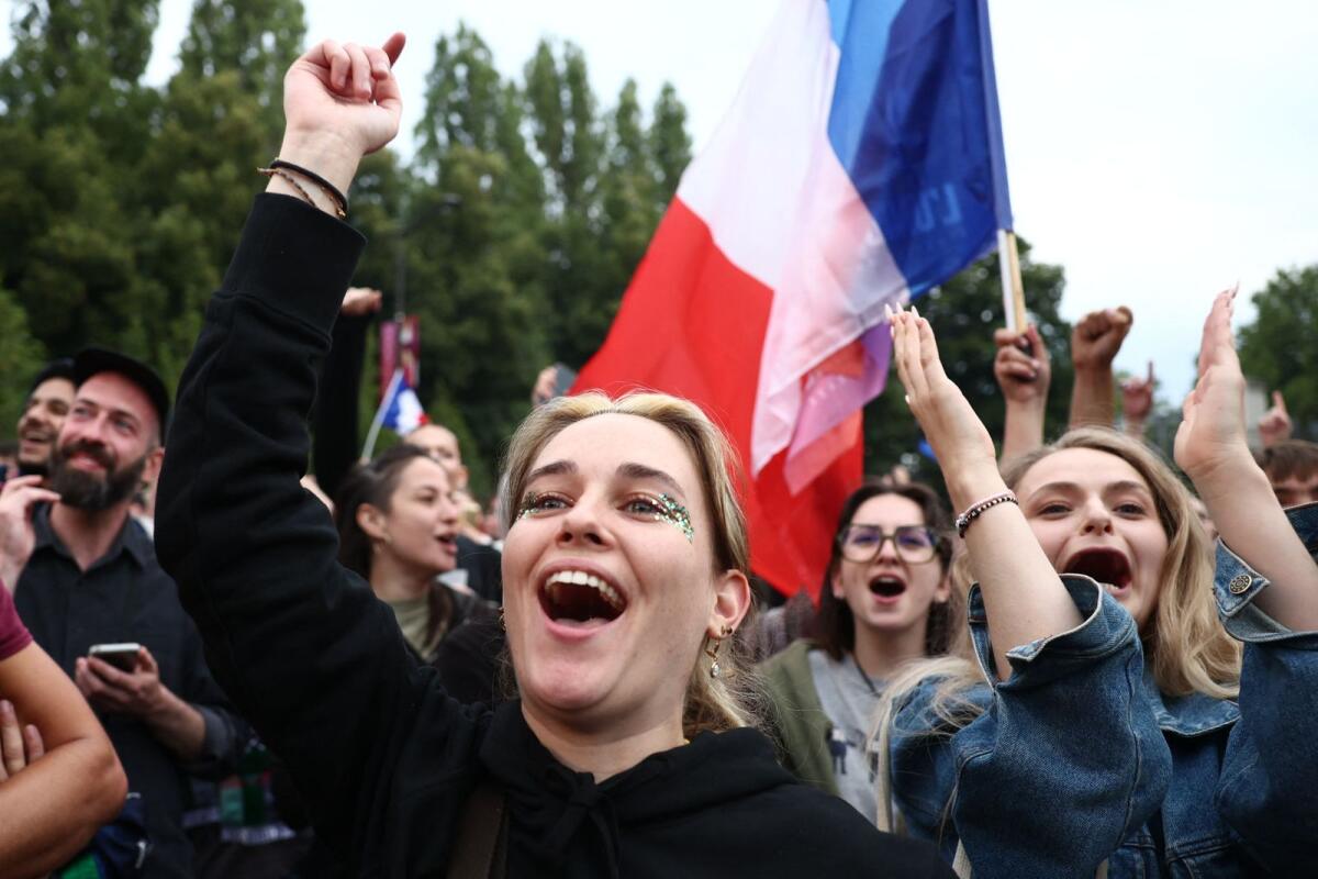 Supporters of French far-left party La France Insoumise react after partial results in the second round of the early French parliamentary elections at Place Stalingrad in Paris, France, July 7, 2024. — Reuters