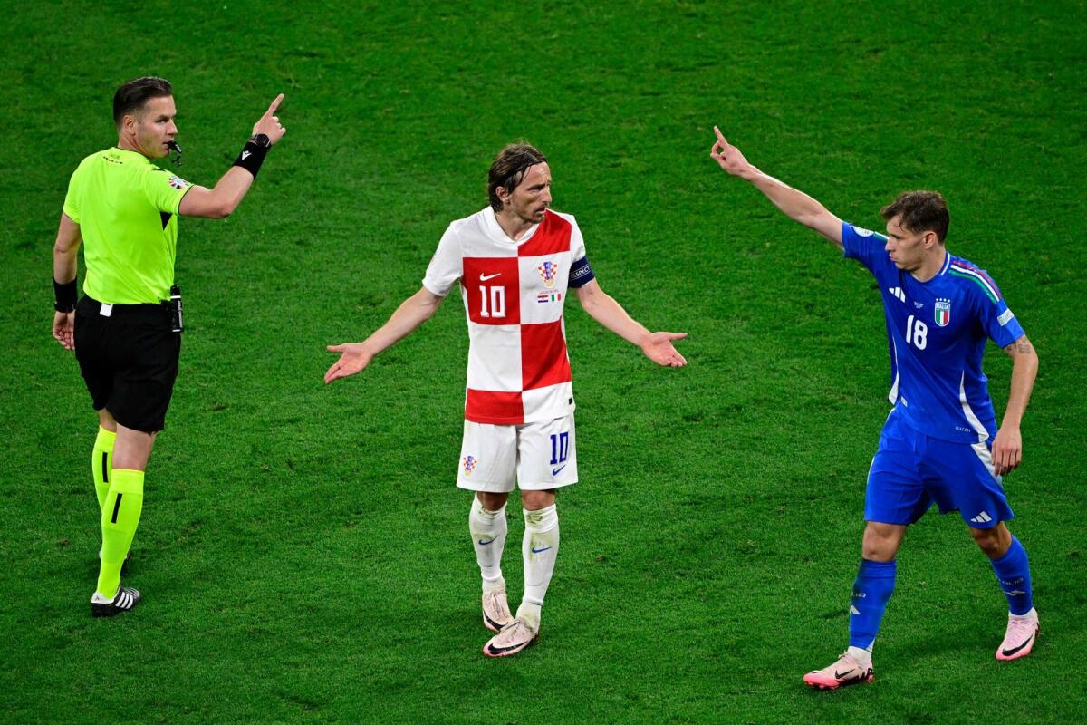 Croatia's midfielder Luka Modric (centre) reacts during the match against Italy. — AFP