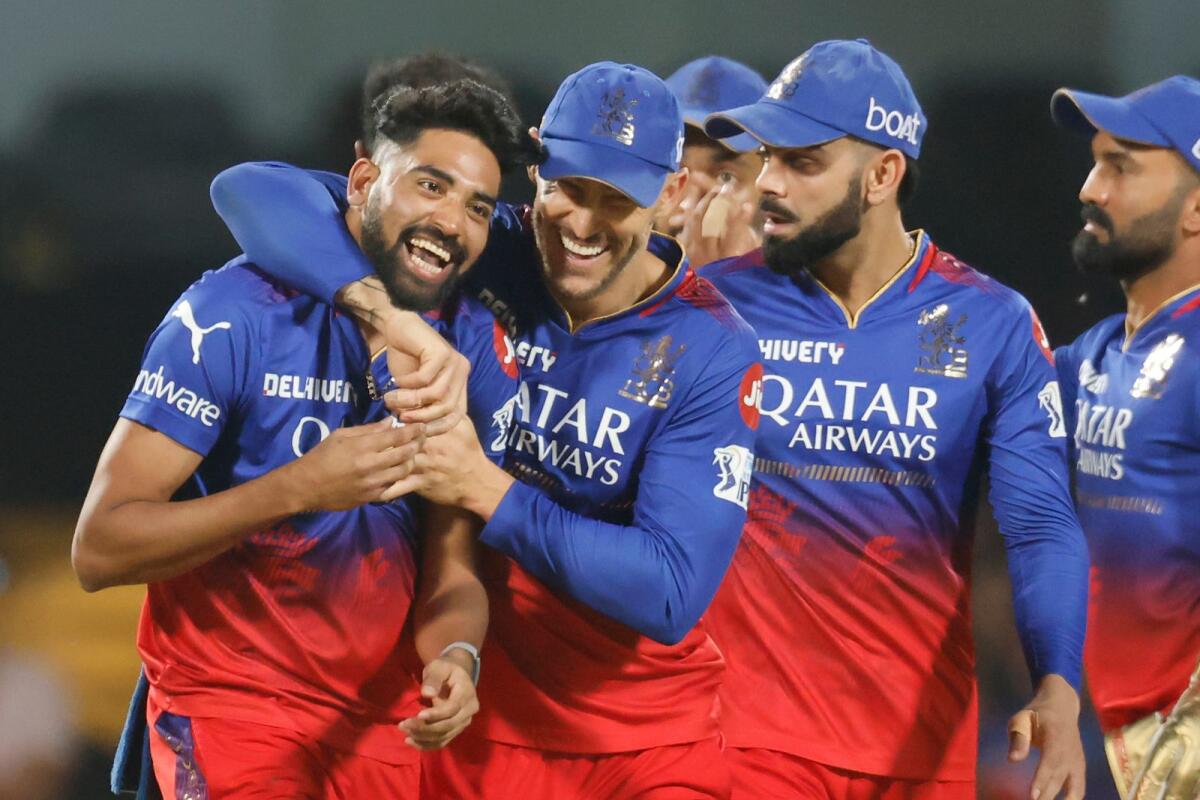 Mohammed Siraj celebrates with RCB teammates after taking the wicket of Wriddhiman Saha of Gujarat Titans. — IPL