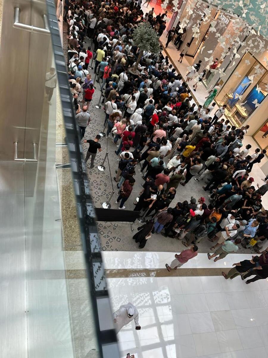 People queue up in front of Apple store in Dubai Mall.