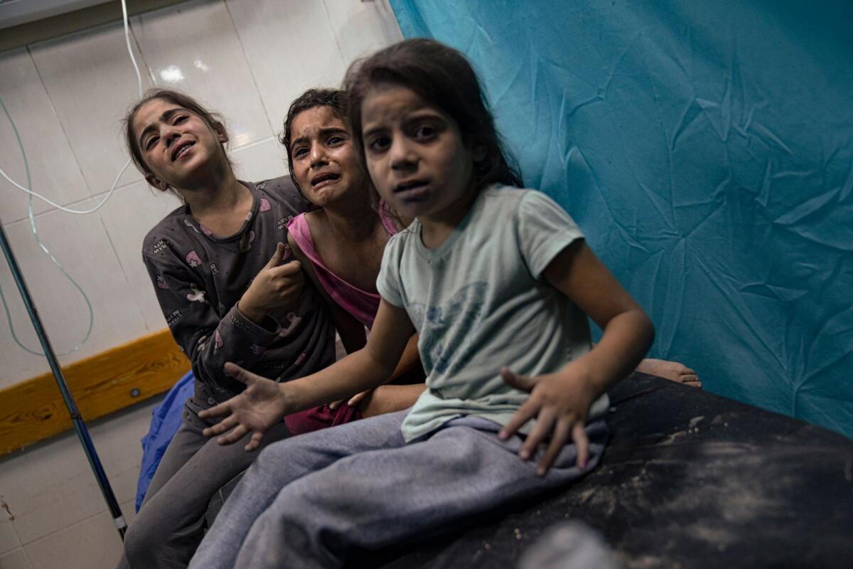Palestinian children wounded in the Israeli bombardment of the Gaza Strip for treatment in a hospital in Khan Younis. — AP