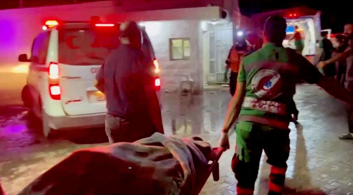 Rescue personnel work at scene At Al-Ahli Hospital, after hundreds of Palestinians were killed in a blast at Al-Ahli hospital in Gaza that Israeli and Palestinian officials blamed on each other in Gaza City, Gaza Strip, in this screen grab obtained from video, October 17, 2023. Photo: Reuters
