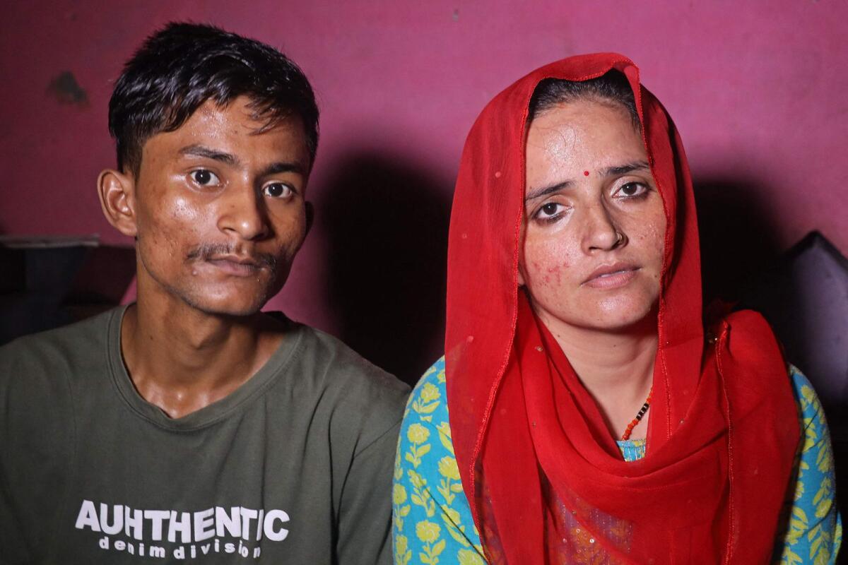 In this photograph taken on July 10, 2023, Sachin Meena (L) and Seema Haider attend a media interview at their residence in Rabupura village, about 90 kilometres (55 miles) from New Delhi. (AFP)