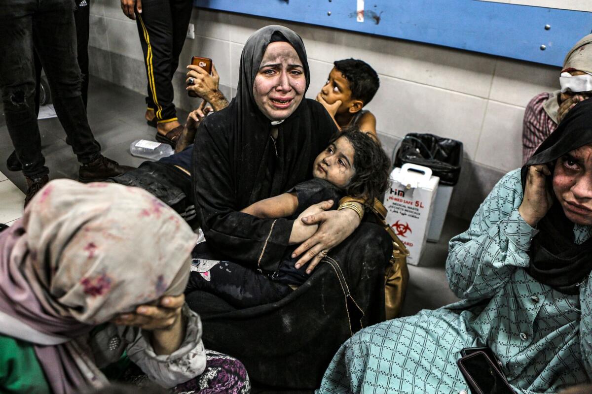 Wounded Palestinians sit in al-Shifa hospital in Gaza City, central Gaza Strip, after arriving from al-Ahli hospital following an explosion there, Tuesday, Oct. 17, 2023. Photo: AP