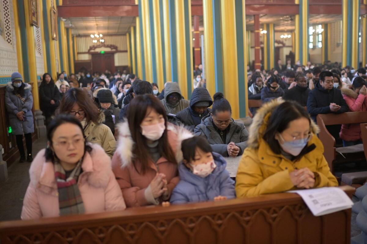 People attend a Christmas mass at the Xishiku Catholic Church in Beijing on December 24. — AFP file photo used for illustrative purpose only
