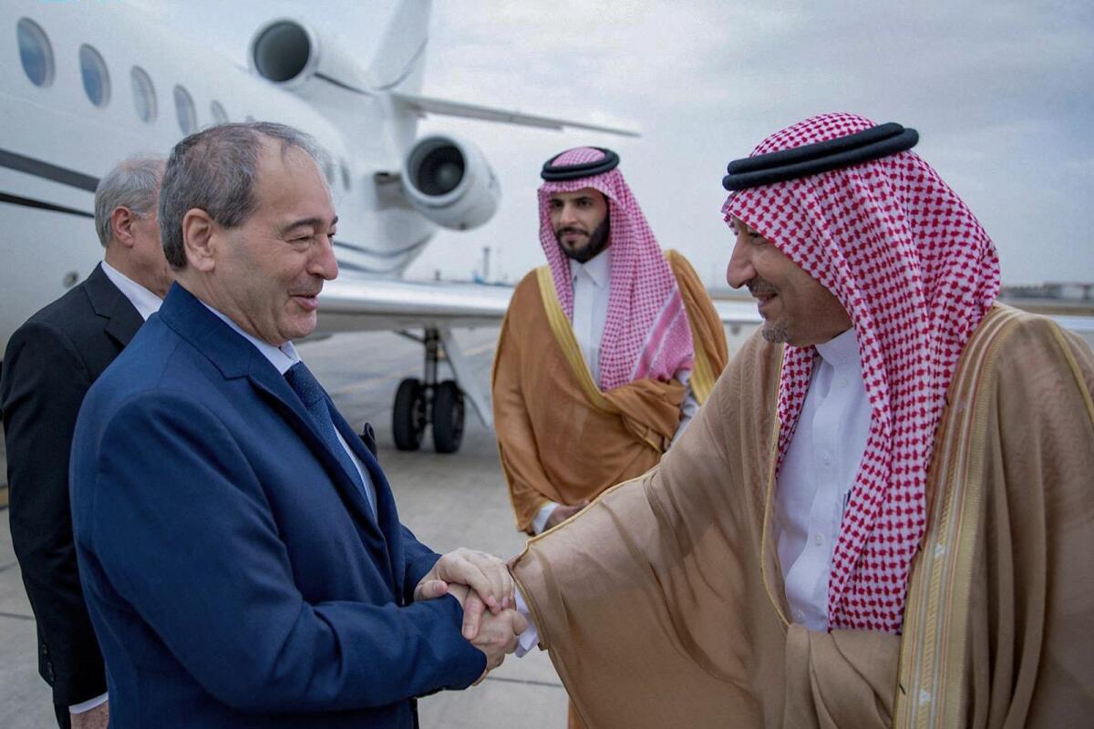Saudi Deputy Foreign Minister Walid Al Khuraiji receiving Syrian Foreign Minister Faisal Mekdad upon his arrival at the airport of Jeddah on Wednesday. — AFP