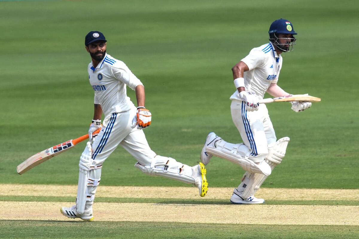 India's KL Rahul(R) and teammate Ravindra Jadeja run between the wickets during second day of the first Test cricket match between India and England. Photo: AFP