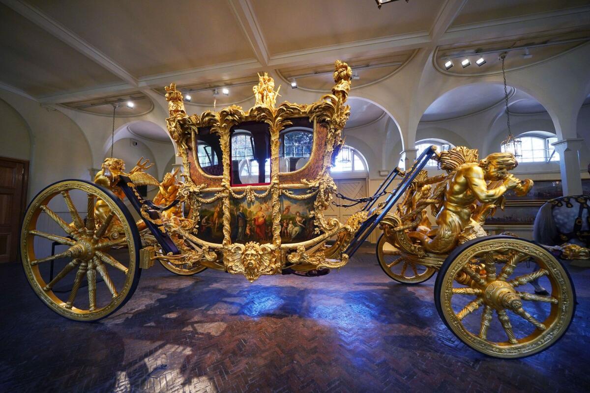 The Gold State Coach on display at the Royal Mews in Buckingham Palace, London, Tuesday April 4, 2023, in which King Charles III and the Queen Consort will return in to Buckingham Palace after the coronation on May 6. -- AP