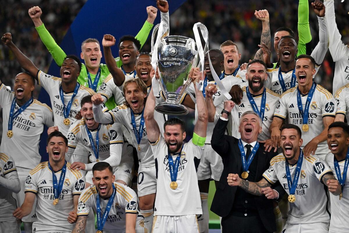 Real Madrid players celebrate with the trophy after winning the Champions League final against Borussia Dortmund. — AFP