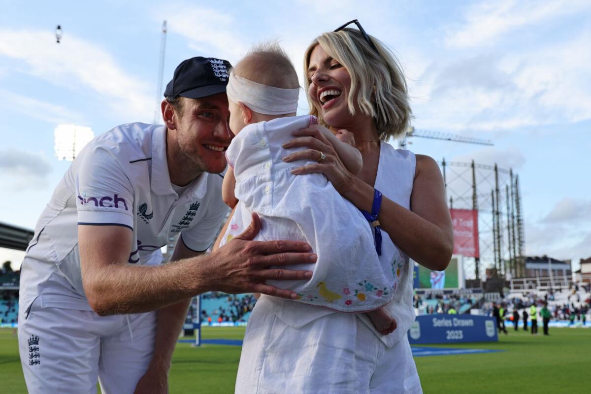 Stuart Broad (left), his partner Mollie King and child Annabella on the field after England's victory. — AFP